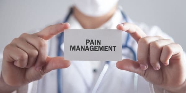 Doctor holding a card that reads - Pain Management