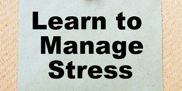 Learn to manage stress written on a white background and sandy coloured pattern